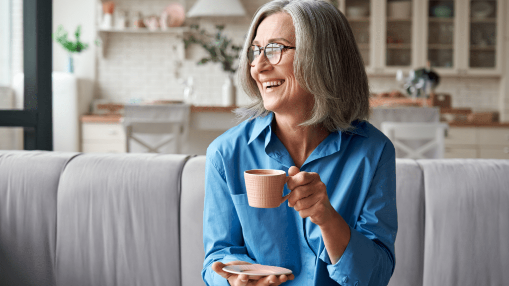 Woman sitting on her sofa drinking coffee