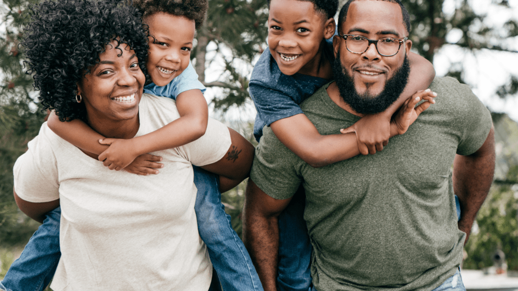 Family of four parents have children on their back