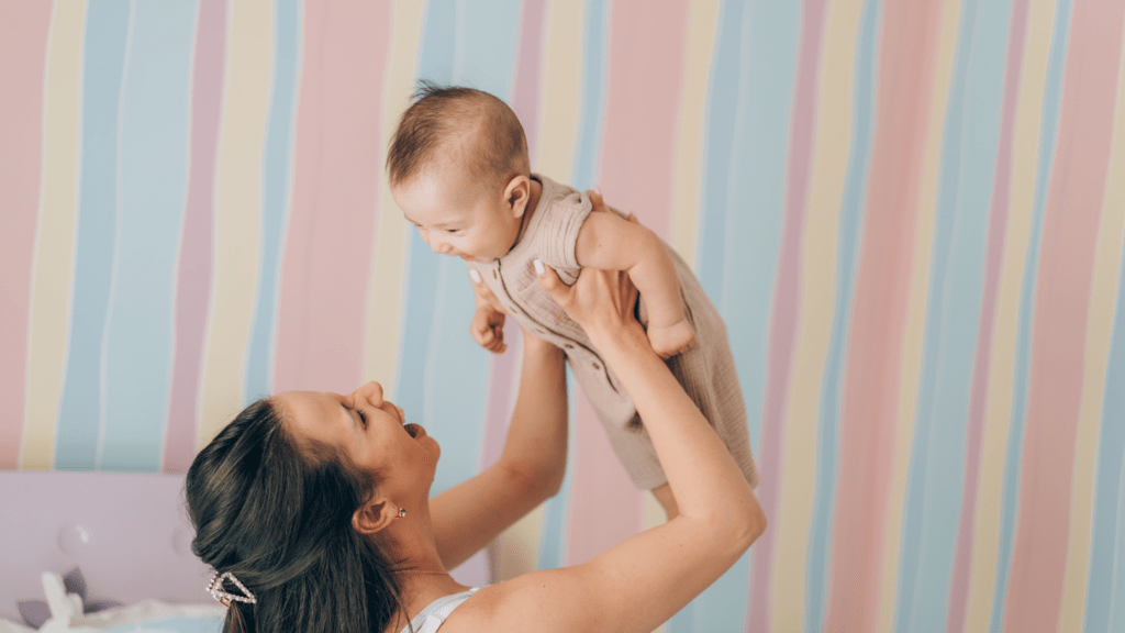 Mother holding child in playroom