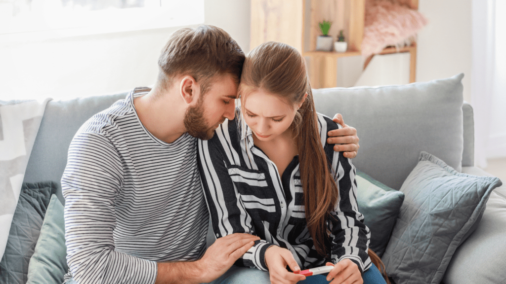 Stressed couple looking at pregnancy test