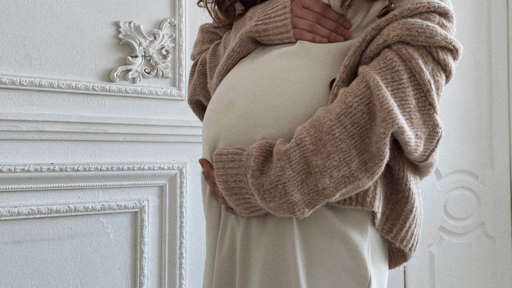 Woman holding pregnant stomach